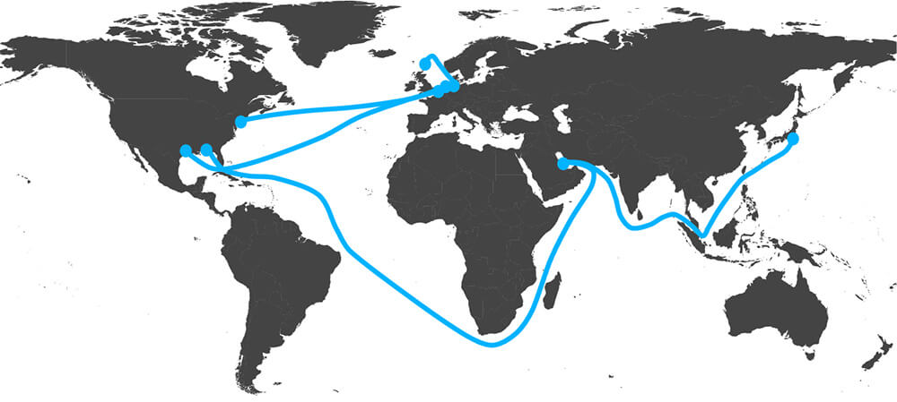 World map with oil shipping routes drawn in blue, from the Persian Gulf to Japan through the Strait of Malacca, from the Gulf around the southern tip of Africa to the US Gulf Coast, and from the US to Northern Europe