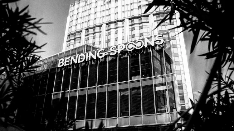 Black and white photo of the Bending Spoons sign on its office tower