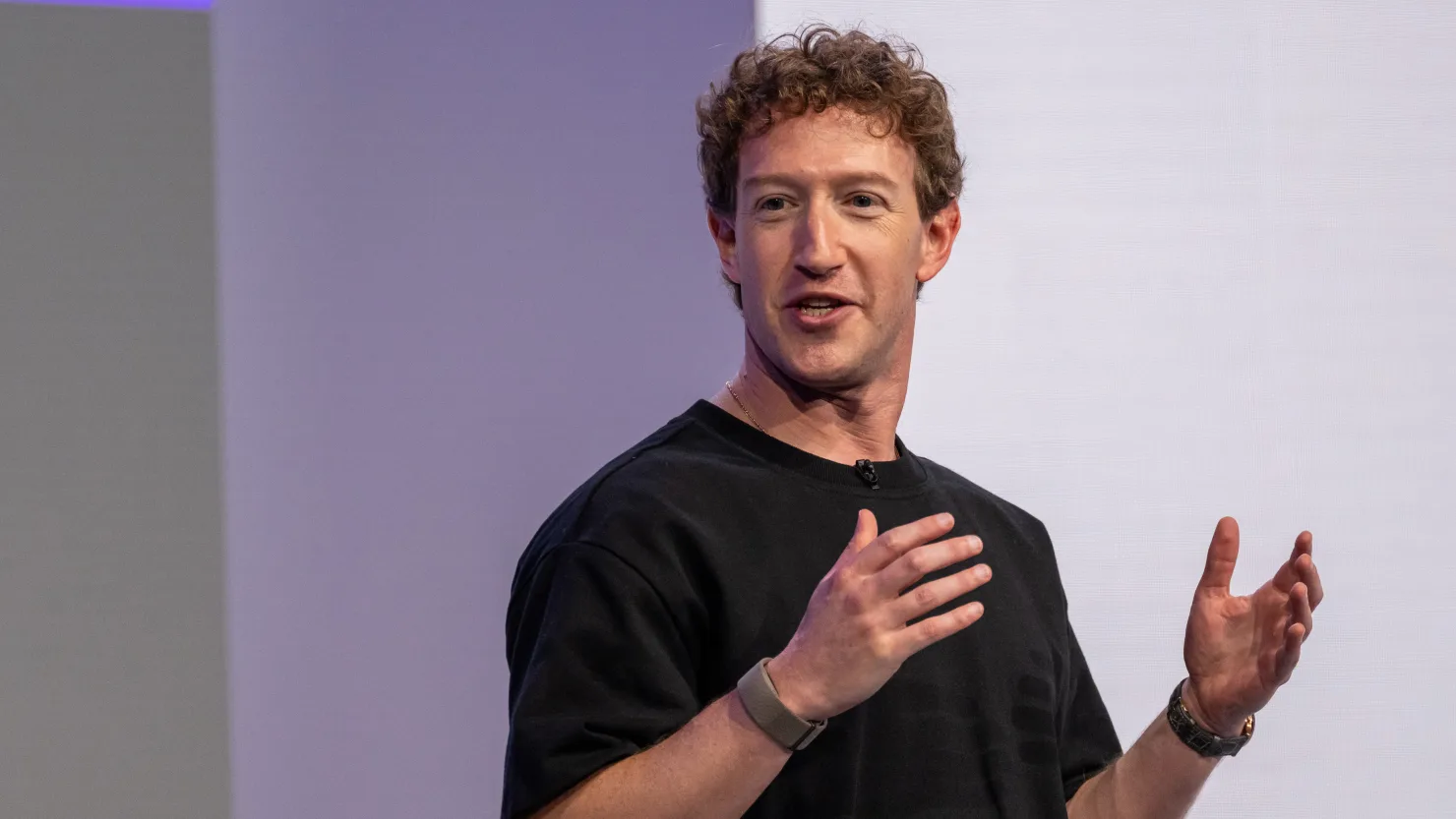 Mark Zuckerberg in a black T-shirt speaking on stage at Meta Connect in Menlo Park, California